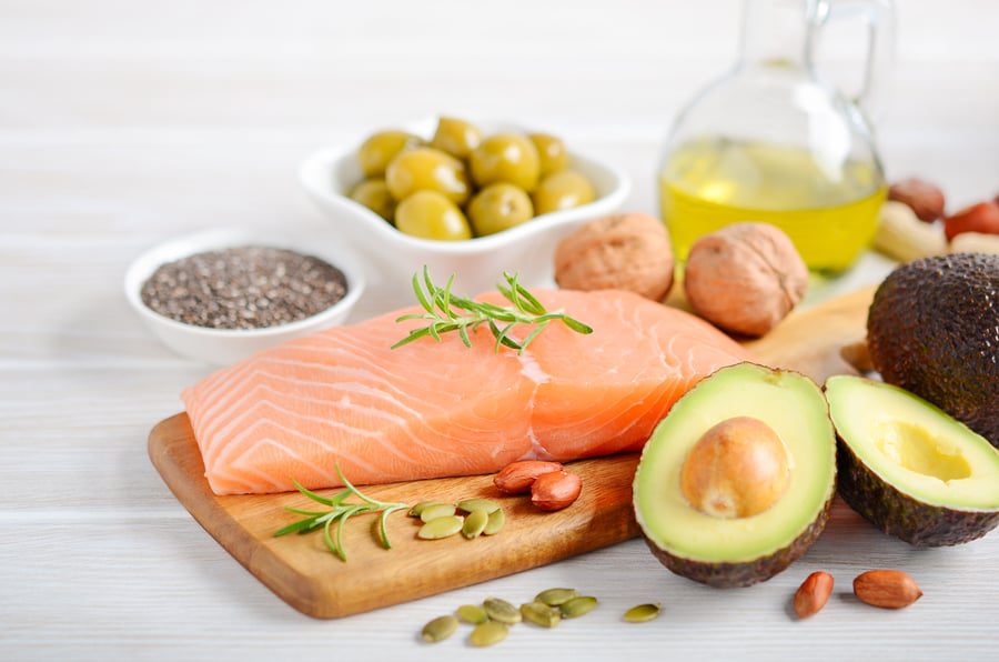 salmon, olives, avocados on a plate