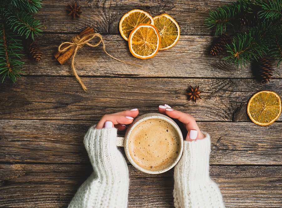 hands around mug of hot chocolate