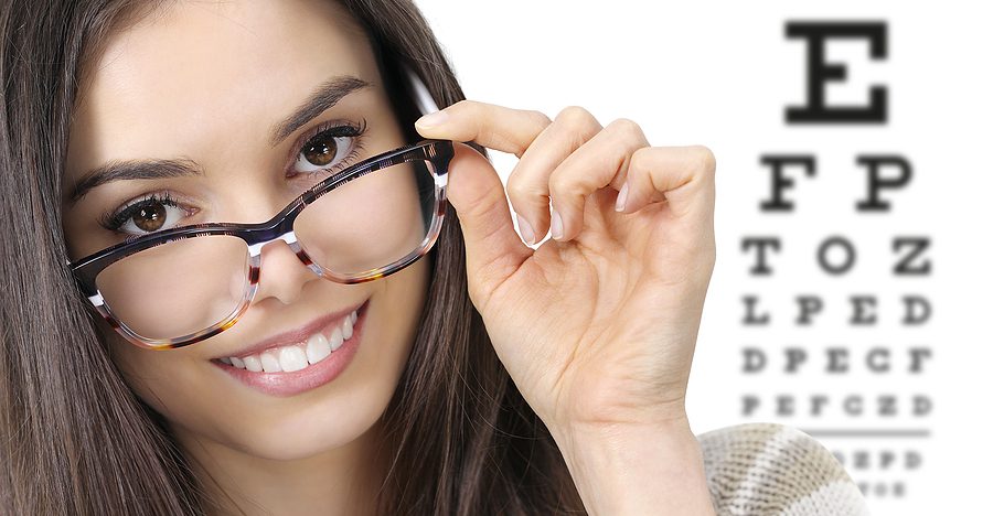 woman wearing eye glasses next to eye chart