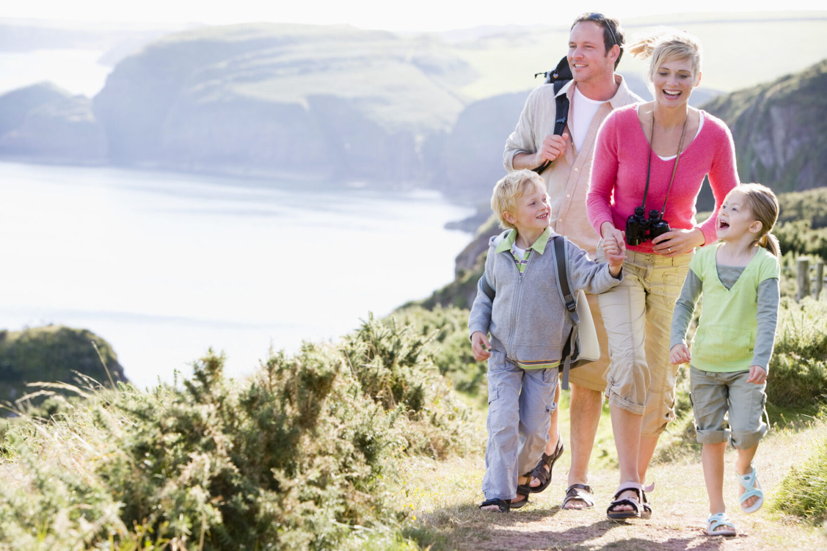 Family on coastal walk across cliffs