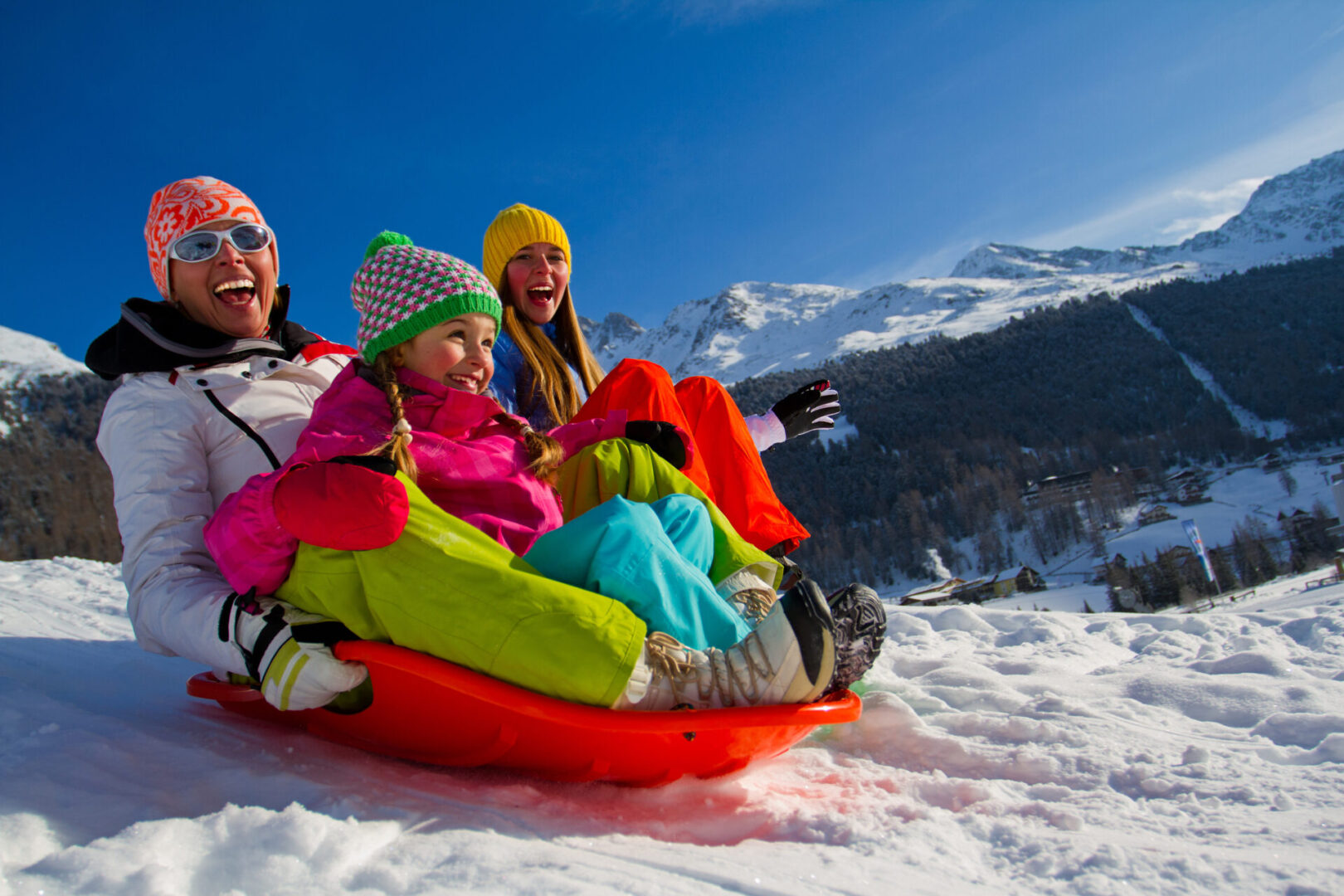 Winter fun, snow, family sledding at winter time