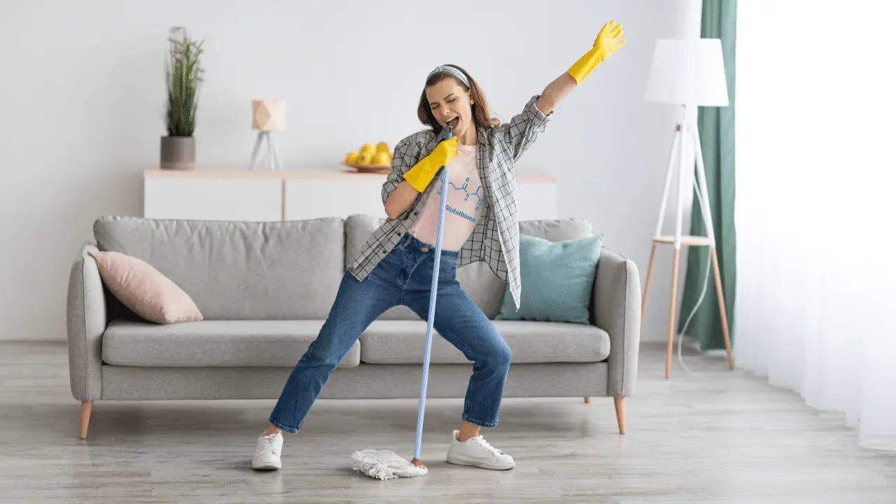 Woman mopping and singing into the mop handle with "glutathione" on her shirt