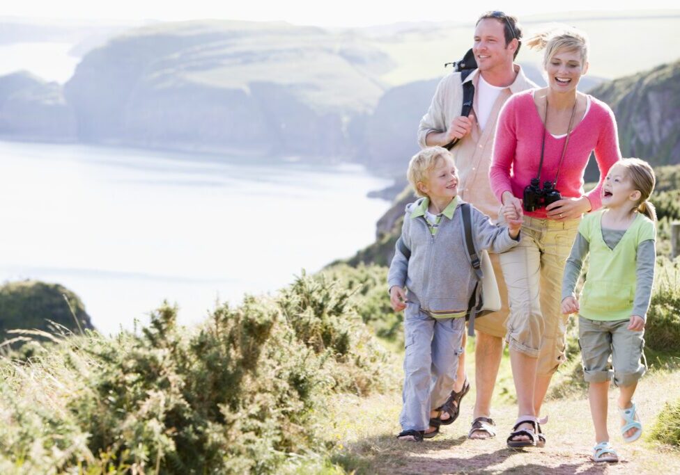 Family on coastal walk across cliffs