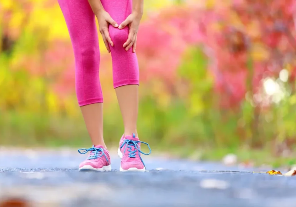 Joint pain while walking outdoors in forest.