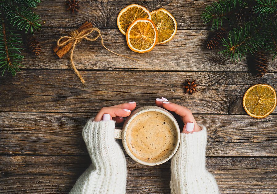 hands around mug of hot chocolate